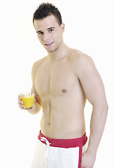 Image showing young athlete dringing orange juice