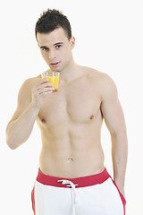 Image showing young athlete dringing orange juice