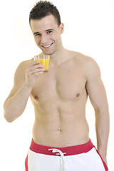 Image showing young athlete dringing orange juice