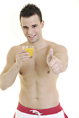 Image showing young athlete dringing orange juice