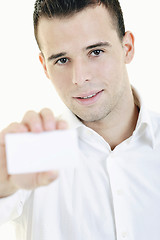 Image showing young business man with empty card isolated on white