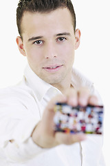 Image showing young business man with empty card isolated on white