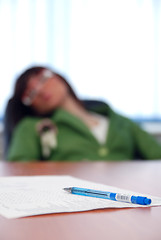 Image showing young businesswoman signing a contract 