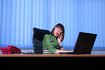 Image showing .young businesswoman working on a laptop computer in the office.