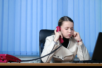 Image showing .young businesswoman working on a laptop computer in the office.