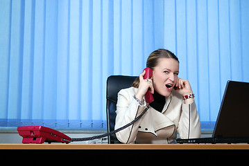 Image showing .young businesswoman working on a laptop computer in the office.