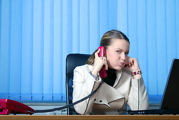 Image showing .young businesswoman working on a laptop computer in the office.