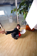 Image showing happy businesswoman throwing documents in office