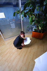 Image showing happy businesswoman throwing documents in office