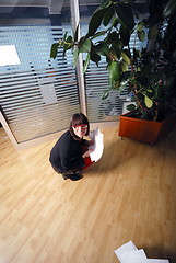 Image showing happy businesswoman throwing documents in office