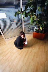 Image showing happy businesswoman throwing documents in office