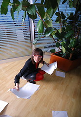 Image showing happy businesswoman throwing documents in office