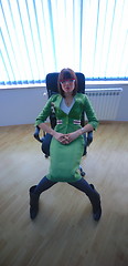 Image showing Businesswoman in green suit seating on office chair