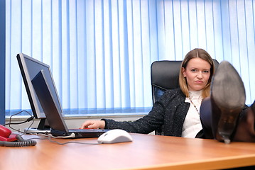 Image showing .business woman relaxing with her feet on the desk