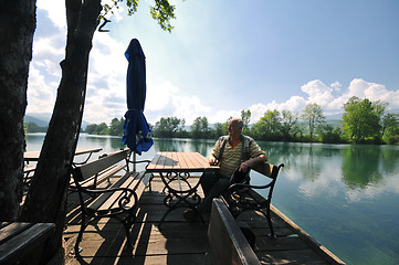 Image showing senior man eat desser at outdoor restaurant