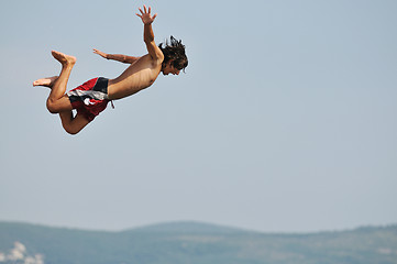 Image showing boy jump sea