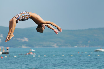 Image showing boy jump sea