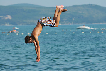 Image showing boy jump sea