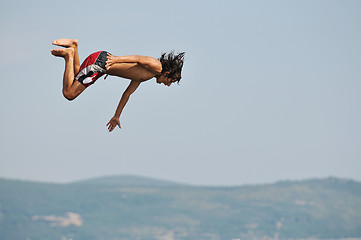 Image showing boy jump sea