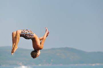 Image showing boy jump sea