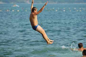 Image showing boy jump sea