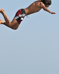 Image showing boy jump sea