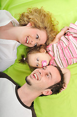 Image showing happy young family together in studio