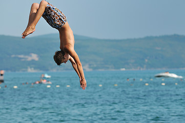 Image showing boy jump sea