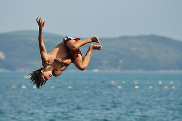 Image showing boy jump sea