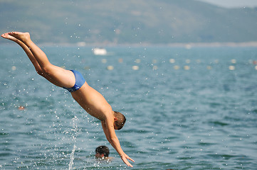 Image showing boy jump sea