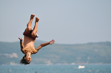 Image showing boy jump sea