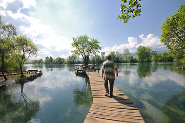 Image showing senior man eat desser at outdoor restaurant