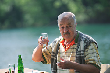 Image showing senior man eat desser at outdoor restaurant