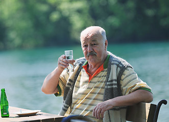 Image showing senior man eat desser at outdoor restaurant