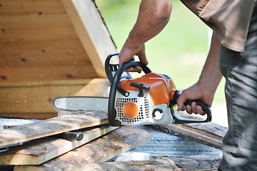 Image showing wood worker with chainshaw closeup