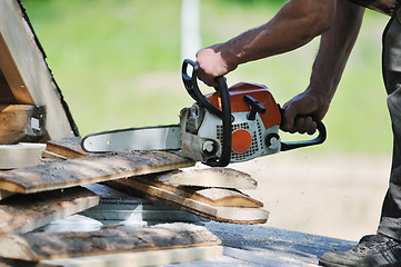 Image showing wood worker with chainshaw closeup