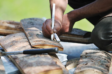 Image showing wood worker with chainshaw closeup