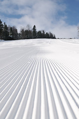 Image showing tracks on ski slopes at beautiful sunny  winter day