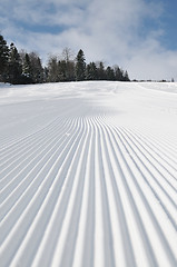 Image showing tracks on ski slopes at beautiful sunny  winter day