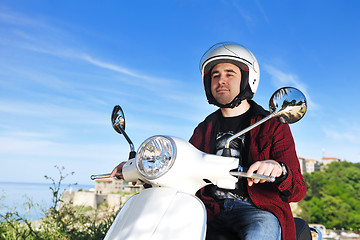Image showing young man ride retro scooter