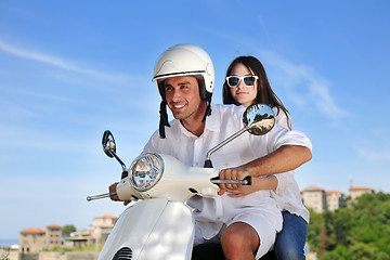 Image showing Portrait of happy young love couple on scooter enjoying summer t