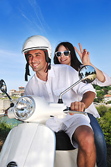 Image showing Portrait of happy young love couple on scooter enjoying summer t