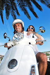 Image showing Portrait of happy young love couple on scooter enjoying summer t