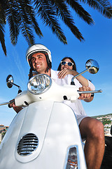 Image showing Portrait of happy young love couple on scooter enjoying summer t