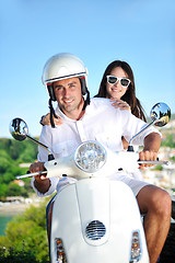 Image showing Portrait of happy young love couple on scooter enjoying summer t