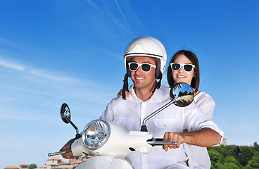 Image showing Portrait of happy young love couple on scooter enjoying summer t