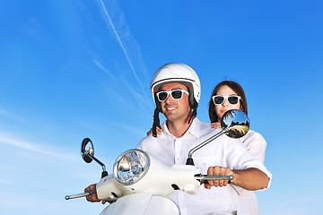 Image showing Portrait of happy young love couple on scooter enjoying summer t