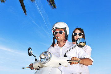 Image showing Portrait of happy young love couple on scooter enjoying summer t