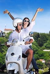 Image showing Portrait of happy young love couple on scooter enjoying summer t