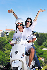 Image showing Portrait of happy young love couple on scooter enjoying summer t